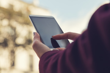 Girl using cellphone outdoors.