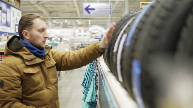 Man chosing new tires in shop