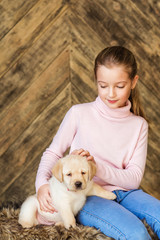 Little girl with a labrador puppy