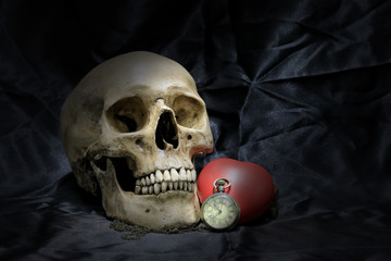Vintage pocket watch with heart and human skull on black background, Concept love and time, still life photography.