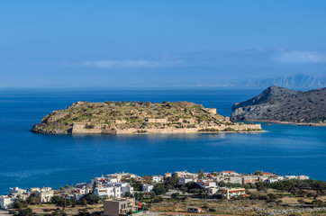 The island of Spinalonga is located in the Gulf of Elounda in north-eastern Crete opposite to the village of Plaka.