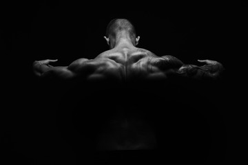 Unrecognizable man shows strong back muscles closeup