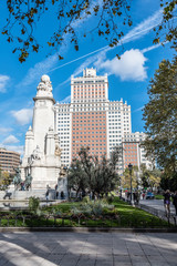 Fototapeta na wymiar Square of Spain in Madrid with Cervantes monument and skyscraper on background. Blue sky day
