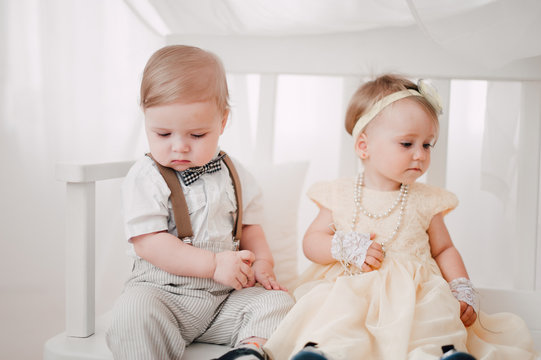 two babies wedding - boy and girl dressed as bride and groom