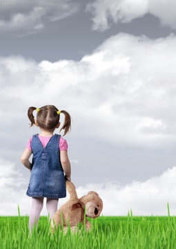 Child Girl With Toy Bear Looking Into The Distance, Back View