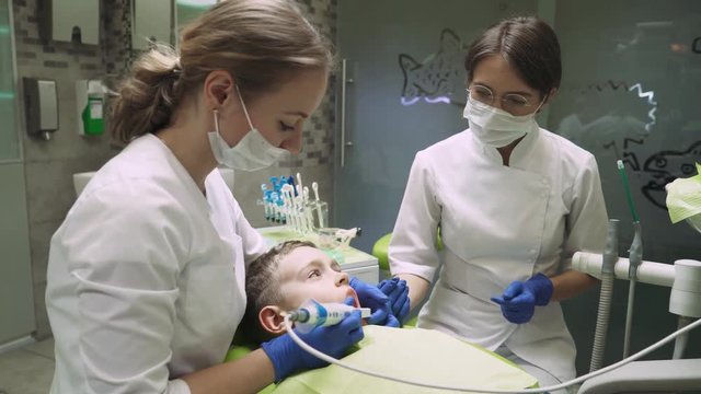 Dentists treat tooth boy. 4k footage. Dental Camera. Close-up.
