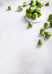 Background with Brussels sprouts on light gray stone table. Healthy food concept with copy space.