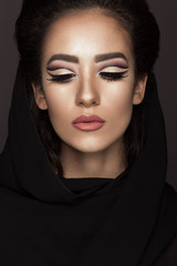 Beautiful girl in the Arab scarf with oriental make-up. Beauty face. Photos shot in the studio.