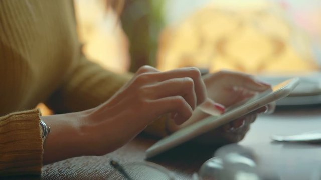 Female Hand touching screen on modern digital tablet pc.