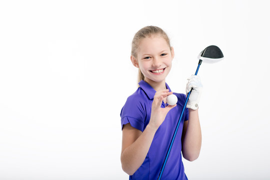 Pretty girl golfer posing with golf club and ball on white backgroud in studio