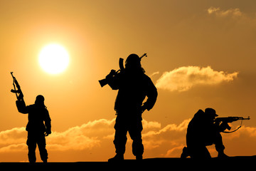 three silhouette of a soldier on a beautiful background