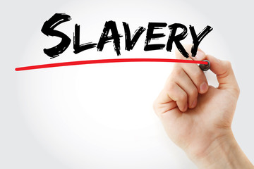 Hand writing Slavery with marker, concept background