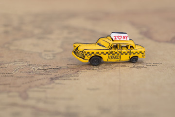 Close up of yellow taxi on map New york - Travel concept.