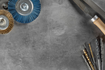 workplace on concrete with drill bit, tools, grinding discs