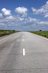 Fototapeta premium Asphalt road over blue sky background.