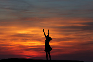 silhouette girl dancing on the background of a beautiful sunset