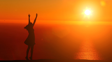 silhouette girl dancing on the background of a beautiful sunset