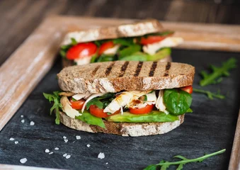 Keuken spatwand met foto Homemade sandwich with avocado, arugula, tomatoes and grilled chicken   © senteliaolga