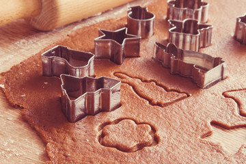 Christmas gingerbread cooking and decoration on the wooden table in the kitchen. Homemade pastries.