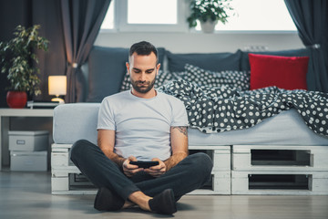 young cell phone addict man using smartphone for chatting, sending text messages