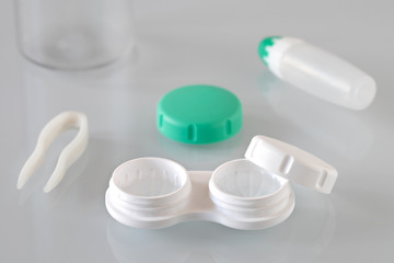 Container for contact lenses, tweezers, glass table