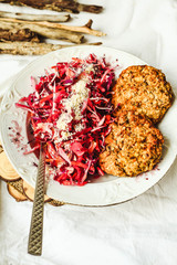 Salad with red cabbage, carrots and beetroot with burgers of bea
