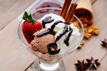Ice cream sundae, waffle cone, walnuts and strawberry 