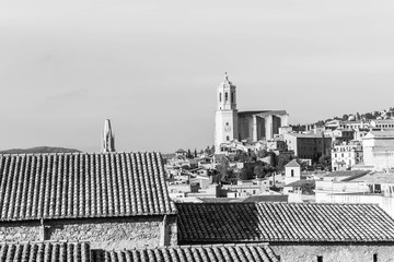 The medieval quarter of Gerona with bell tower of Santa Maria cathedral in background. View from The Forca Vella. Gerona, Costa Brava, Catalonia, Spain. Monochrome image: black and white.
