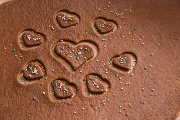 Christmas gingerbread cooking and decoration on the wooden table in the kitchen. Homemade pastries.