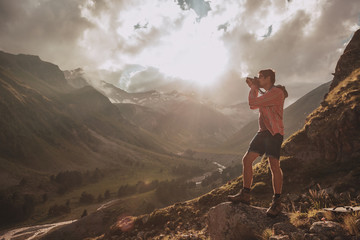 Fototapeta premium Man Traveler hiking Travel Lifestyle concept beautiful mountains landscape on background Summer journey adventure vacations outdoor