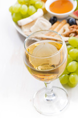 glasses of white wine and snacks , closeup