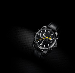 close up view of nice man's wrist watch on black background