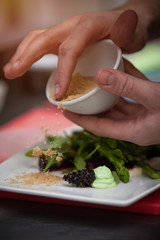 Male chef preparing salad with arugula and beet