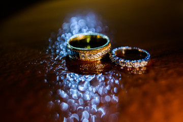 Wedding rings with water droplets against