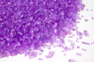 closeup of a violet bath salt on white