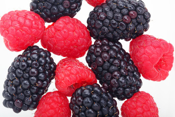 colorful raspberry and blackberry isolated on white background.