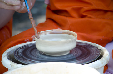 Potter during the proccess of making dish