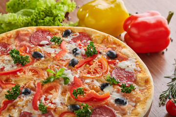 Tasty hot pizza with salami and pepper