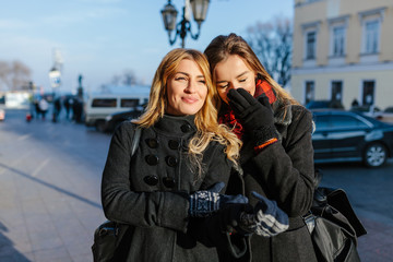 Girls walk and perfectly spend time. They enjoy a fine sunny weather. They giggle and good talk....