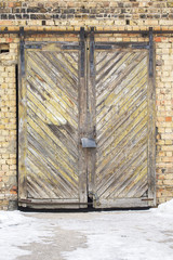 grunge wooden plank door, brick wall background