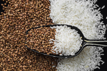 Rice and buckwheat on a wooden background