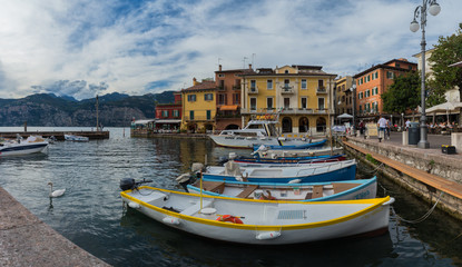 Fototapeta na wymiar MALCESINE, ITALY – SEPTEMBER 16: Malcesine on Garda Lake, Italy. Buildings and boats in the harbor. On September 17 in Malcesine, Italy