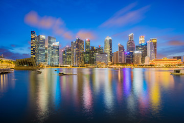Fototapeta na wymiar Singapore city skyline at night by Marina bay