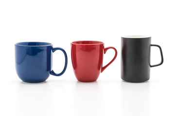 Set of black, red and blue cups on white