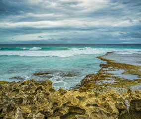 Beautiful eroded rocks on rugged ocean coastline. Stormy weather and rough seas