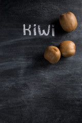 Kiwi over dark chalkboard background
