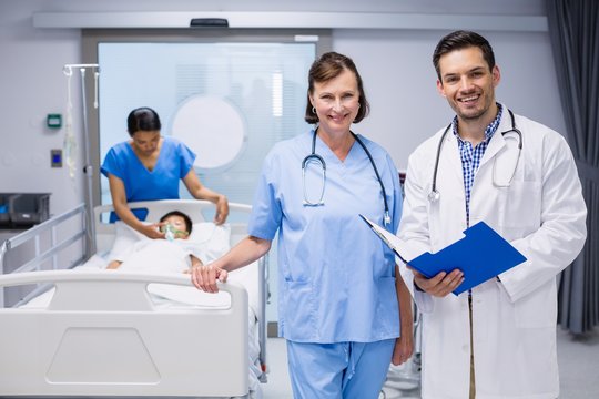 Portrait Of Two Doctors Standing With Medical Report