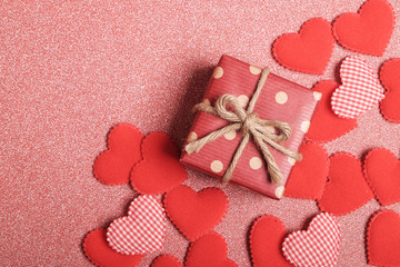 Gift box and heart shaped on red background.