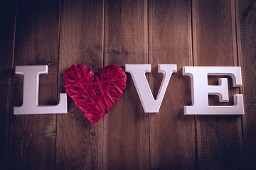 Valentine concept on wooden table with white letters