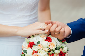 wedding bouquet closeup in the hands of the bride and groom